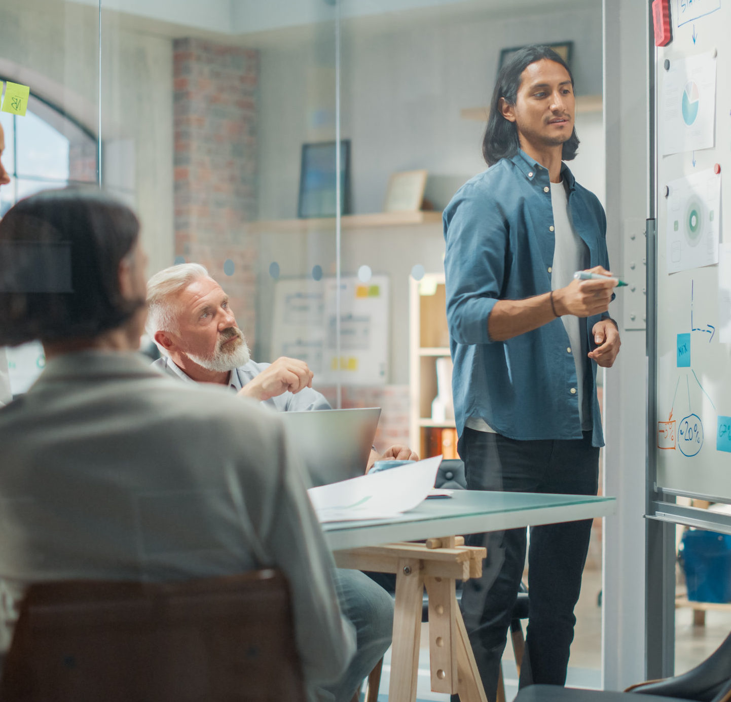 Multiethnic Business Team Discussing Strategy in a Meeting Room